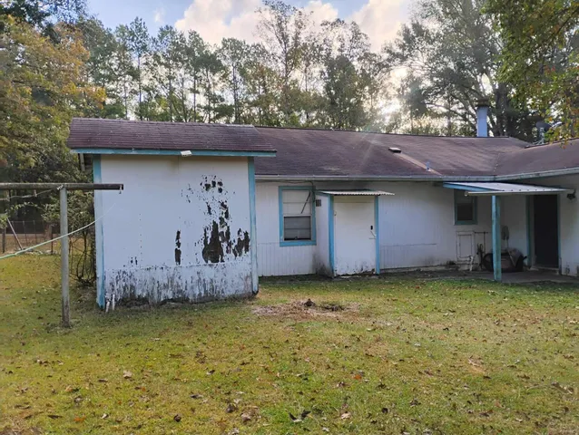 a front view of house with yard and trees