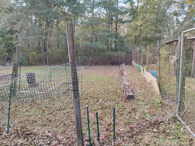 a view of a pathway with a wrought fence