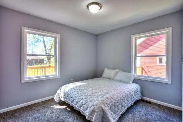 a bedroom with a bed and a window