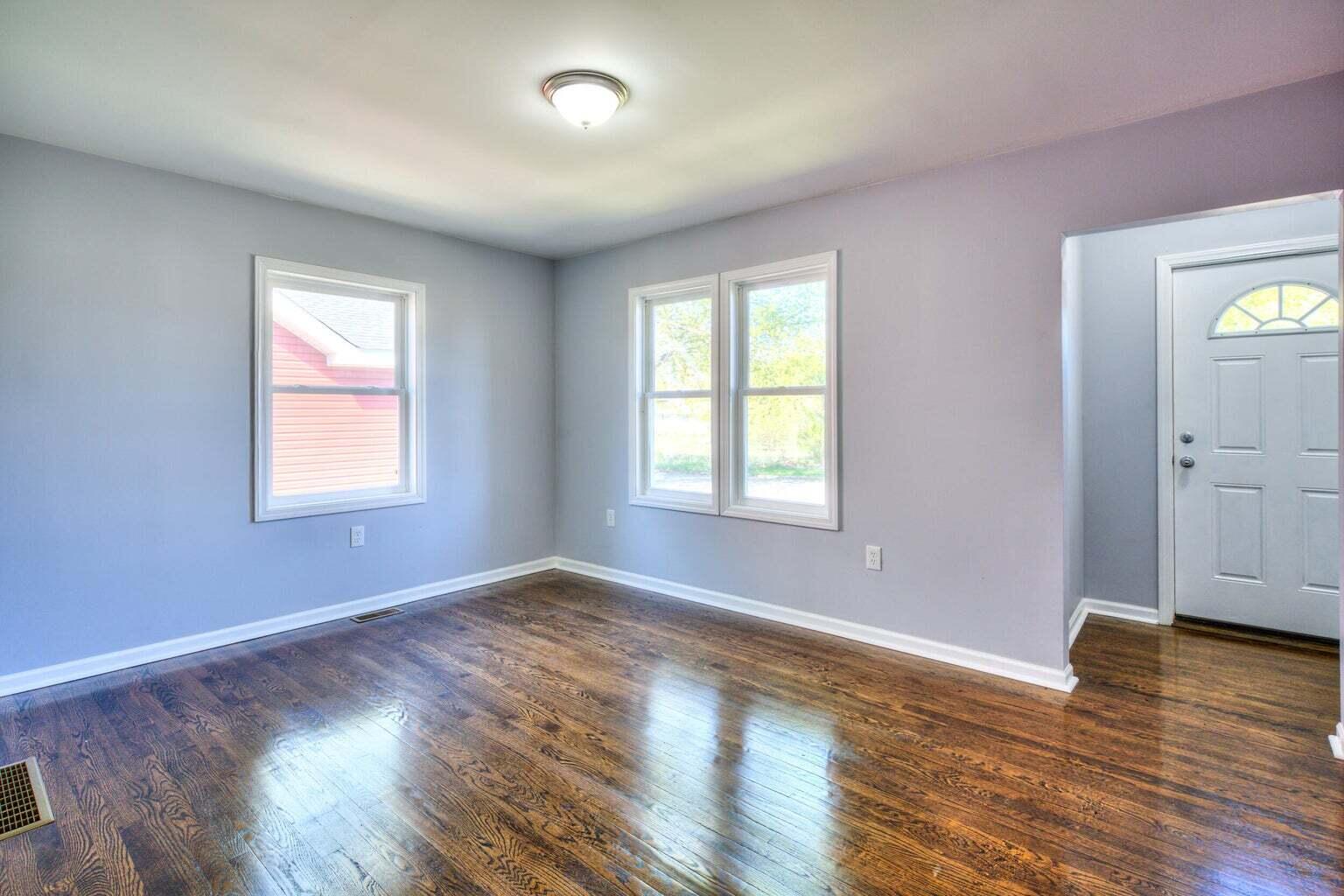 1330 Taney Place Gary, IN 46404 - Photo 2 of 19 an empty room with wooden floor and windows