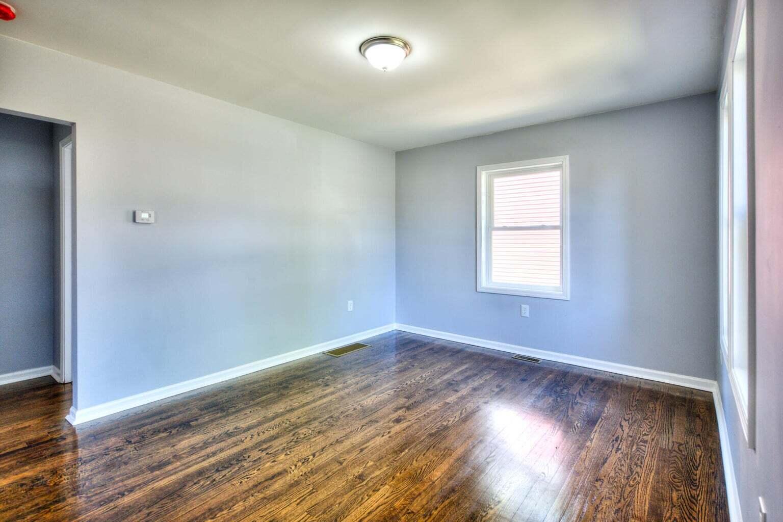 1330 Taney Place Gary, IN 46404 - Photo 4 of 19 an empty room with wooden floor and windows