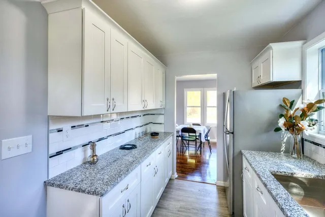 a kitchen with stainless steel appliances granite countertop a sink stove and cabinets