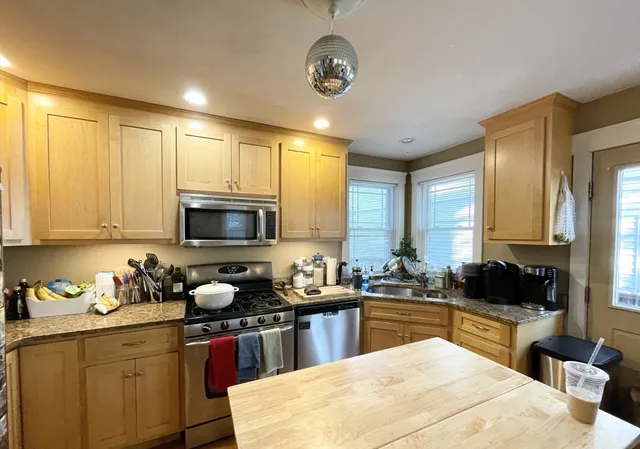 a kitchen with a sink stove and microwave