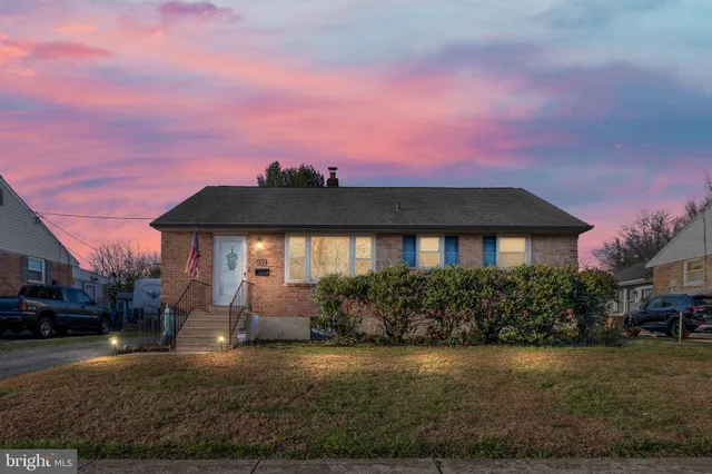 a front view of a house with a yard and a garage