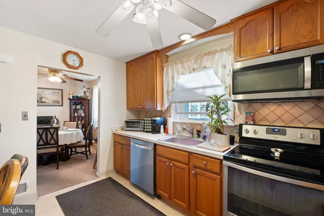 a kitchen with stainless steel appliances a stove sink microwave and cabinets