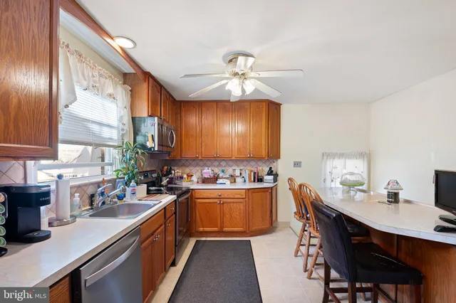 a kitchen with lots of counter top space a sink and appliances