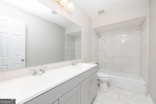 a bathroom with a sink a toilet and bathtub