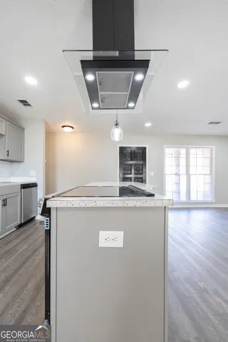a view of kitchen with stainless steel appliances granite countertop cabinets and wooden floor