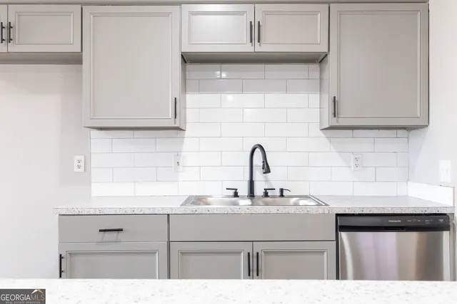 a kitchen with cabinets appliances and a sink