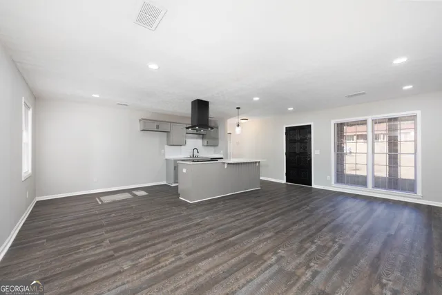 a view of kitchen with refrigerator and window