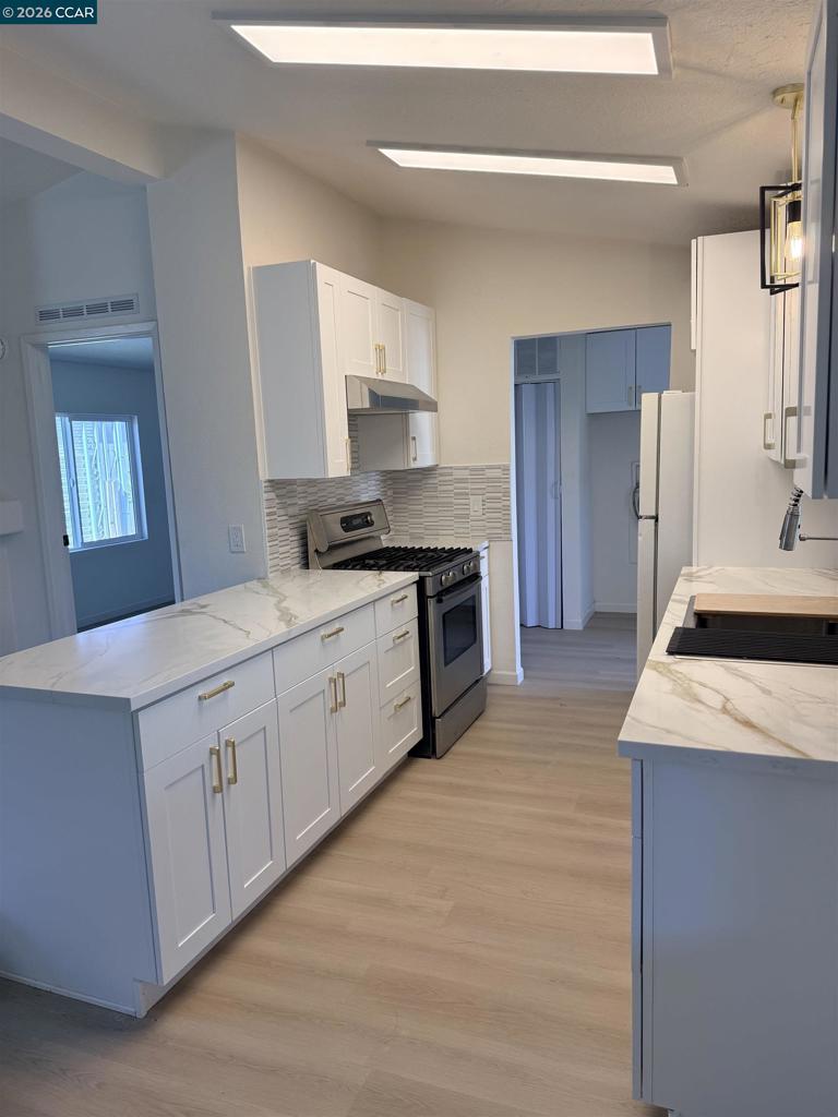 60 Wilson Way Milpitas, CA 95035 - Photo 8 of 22 a kitchen with stainless steel appliances granite countertop a sink stove and refrigerator