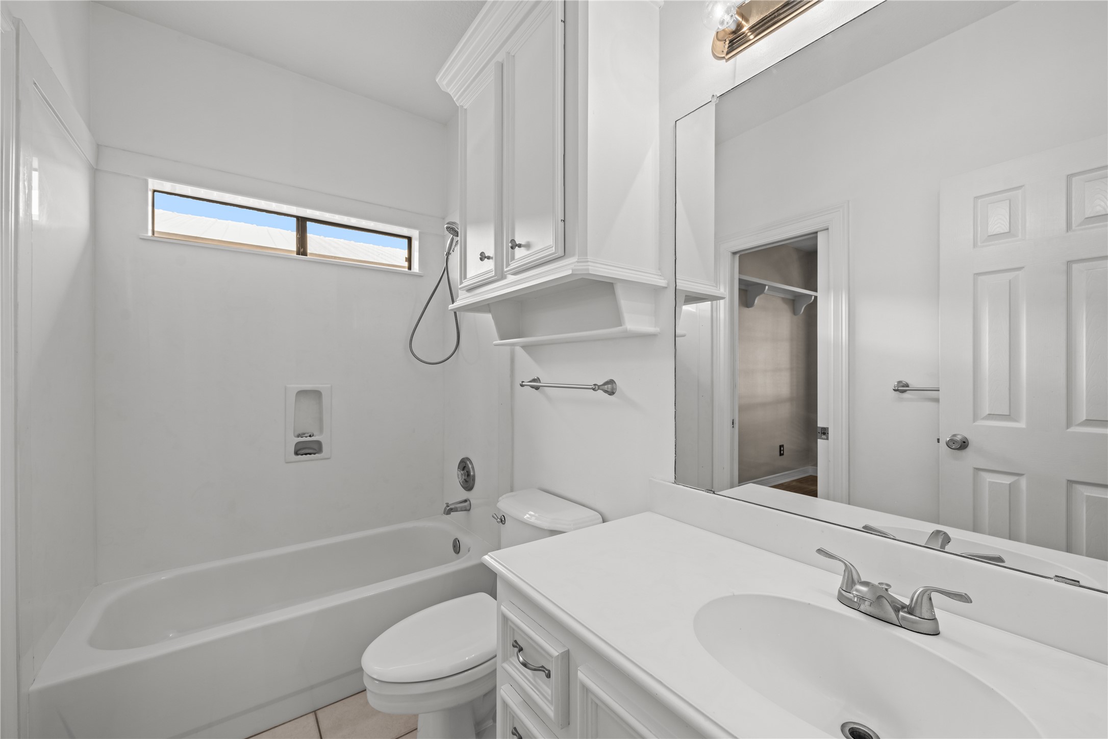 20240 Cypress Rosehill Road Tomball, TX 77377 - Photo 19 of 26 a bathroom with a sink a toilet and shower
