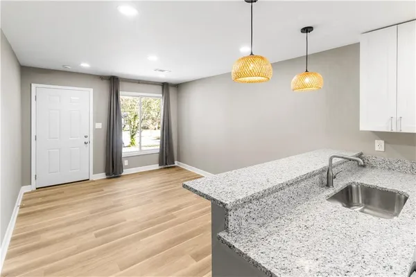 a kitchen with a sink dishwasher and a stove