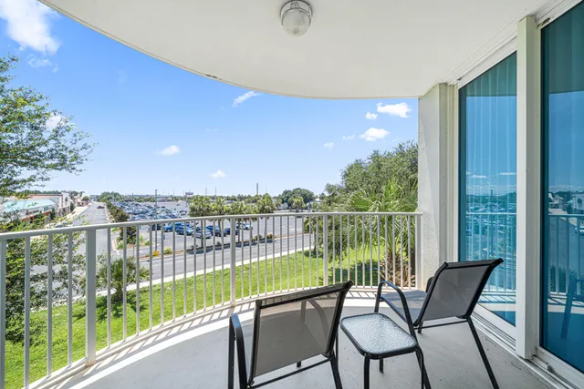 a view of a chair and tables in the balcony