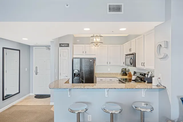 a kitchen with stainless steel appliances a sink and a refrigerator