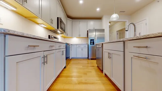 a kitchen with cabinets and stainless steel appliances