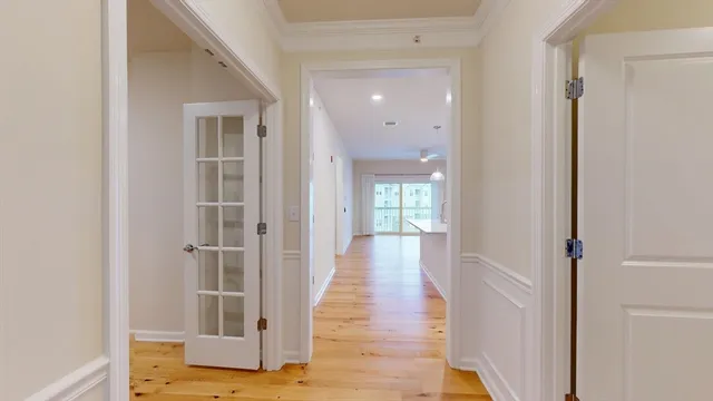 a view of a hallway with wooden floor and entryway