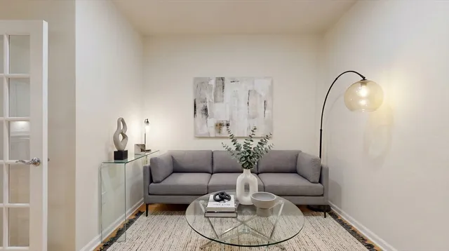 a living room with furniture and a mirror