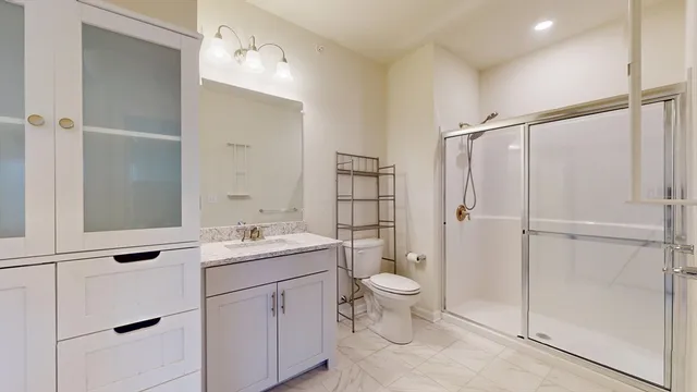 a bathroom with a sink toilet and shower