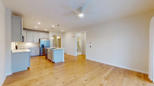 a open kitchen with white cabinets and stainless steel appliances