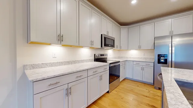 a kitchen with a sink stove and refrigerator