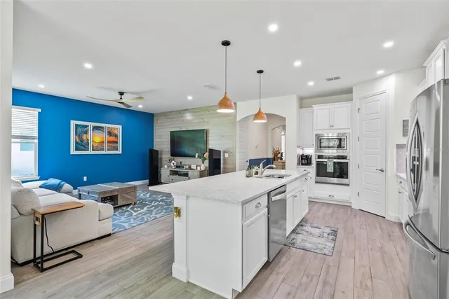 a kitchen with white cabinets and appliances
