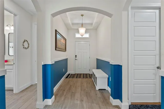 a very nice looking dining room with wooden floor and furniture