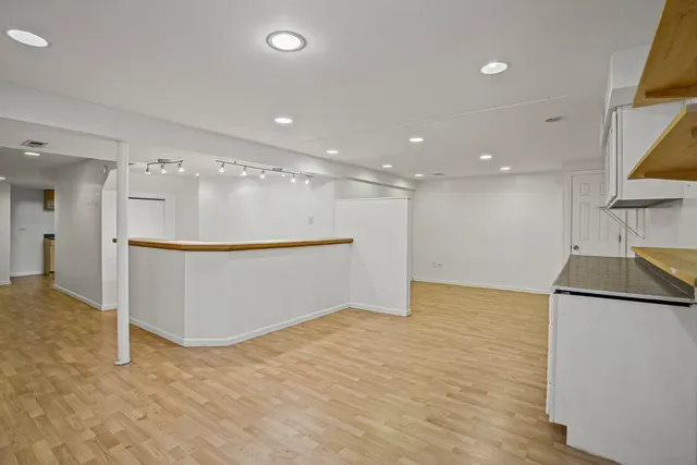 a view of a kitchen with a sink and a refrigerator