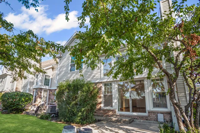 front view of a house with a tree