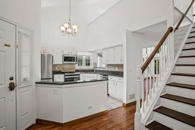 a view of kitchen with sink microwave and refrigerator