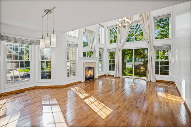 a view of empty room with floor to ceiling windows and yard