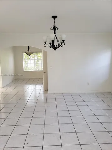 an empty room with windows and entrance