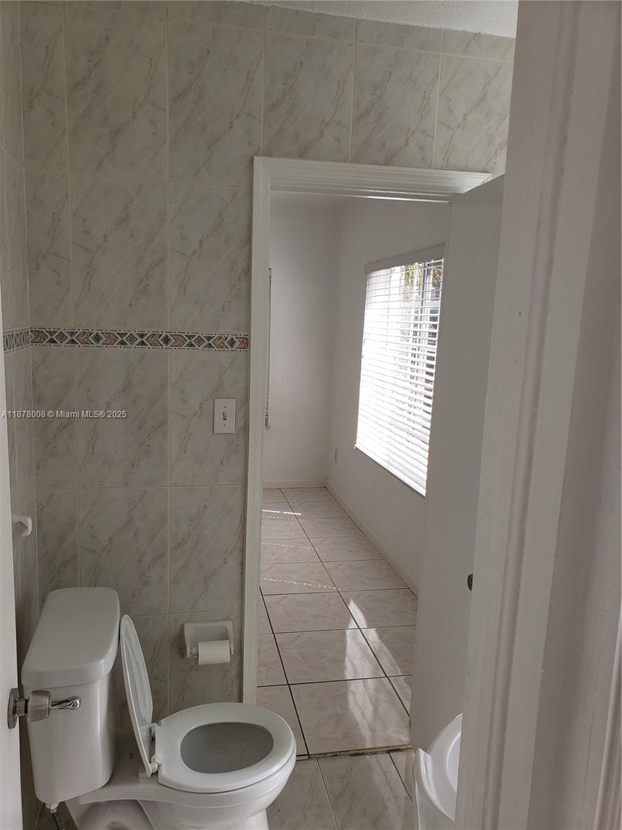 6912 Northeast 5th Avenue, Unit 2 Miami, FL 33138 - Photo 15 of 18 a bathroom with a toilet and a sink