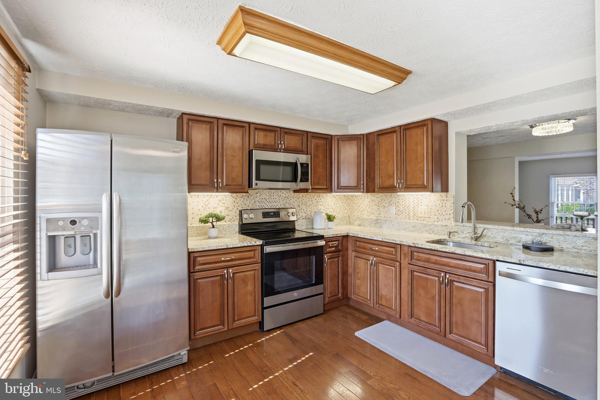 6167 Morning Glory Road Alexandria, VA 22310 - Photo 14 of 39 a kitchen with a sink stainless steel appliances and cabinets