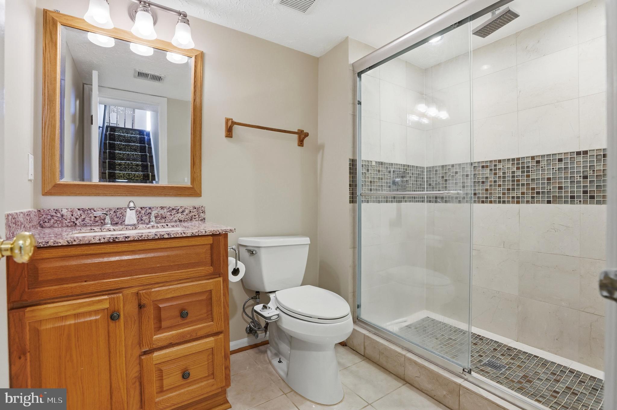 6167 Morning Glory Road Alexandria, VA 22310 - Photo 27 of 39 a bathroom with a sink a toilet and shower