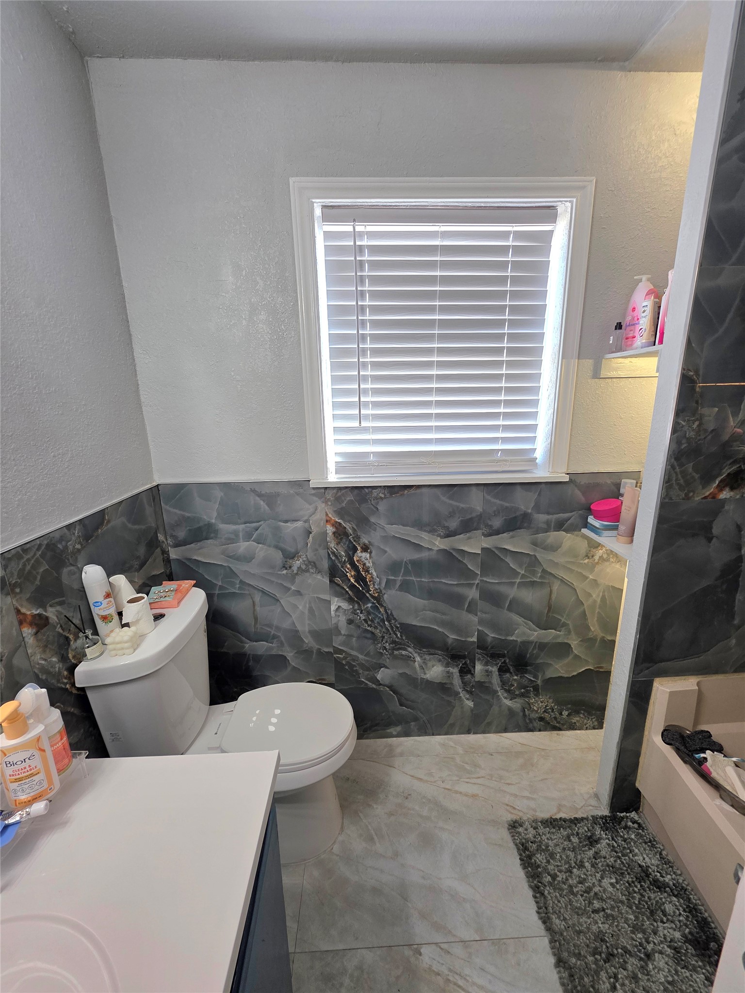 805 Sissom Road Killeen, TX 76541 - Photo 34 of 35 Full bath with tile walls, a textured wall, wainscoting, vanity, and a tub