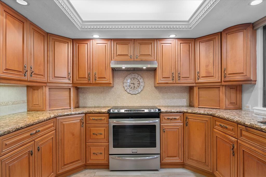 184 Colony Point Drive Punta Gorda, FL 33950 - Photo 12 of 58 a kitchen with granite countertop stainless steel appliances wooden cabinets and a sink