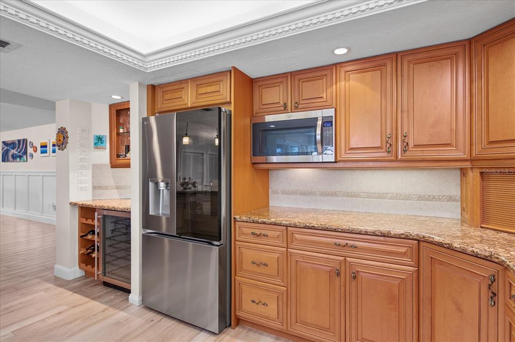 184 Colony Point Drive Punta Gorda, FL 33950 - Photo 13 of 58 a kitchen with stainless steel appliances granite countertop a refrigerator and cabinets