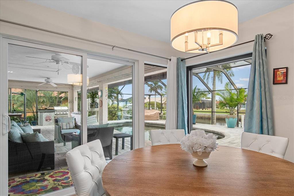184 Colony Point Drive Punta Gorda, FL 33950 - Photo 15 of 58 a view of a dining room with furniture window and wooden floor