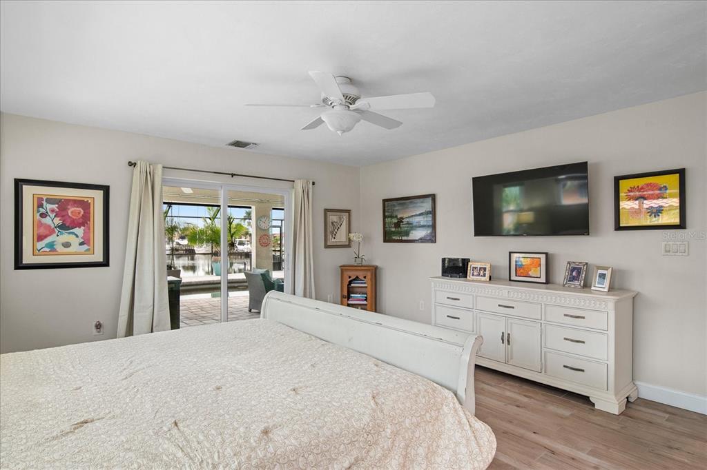 184 Colony Point Drive Punta Gorda, FL 33950 - Photo 26 of 58 a bedroom with a bed and a flat screen tv