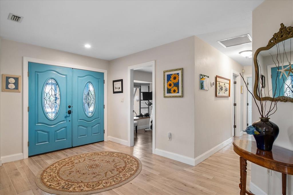 184 Colony Point Drive Punta Gorda, FL 33950 - Photo 3 of 58 wooden floor with cabinet and a living room