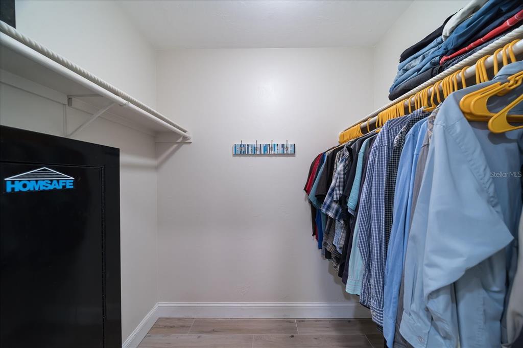184 Colony Point Drive Punta Gorda, FL 33950 - Photo 33 of 58 a view of walk in closet with clothes and shoes