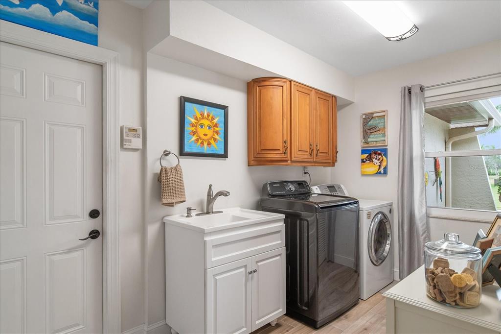 184 Colony Point Drive Punta Gorda, FL 33950 - Photo 42 of 58 a bathroom with a sink a washer and dryer