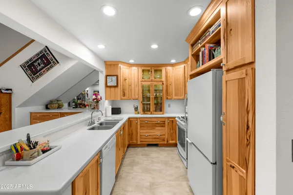a kitchen with stainless steel appliances a stove a refrigerator sink and cabinets