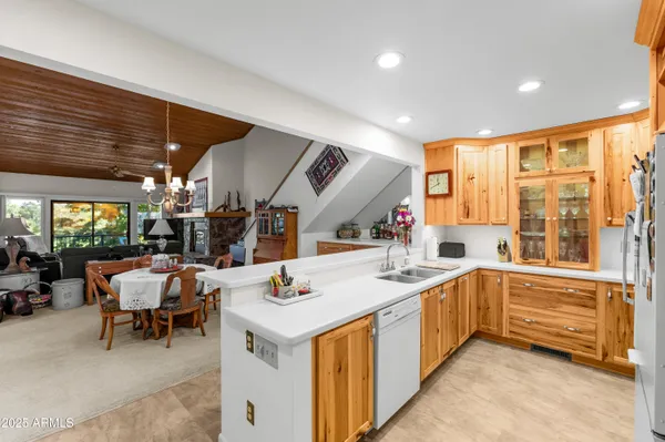 a living room with stainless steel appliances kitchen island granite countertop furniture and a large window