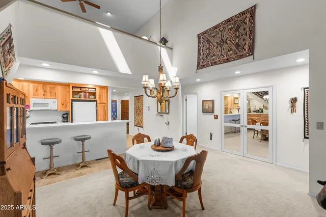 a living room with furniture a flat screen tv and a floor to ceiling window