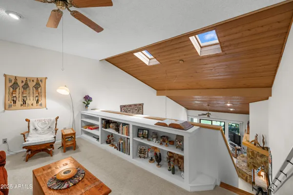 a view of a dining room with furniture and a chandelier