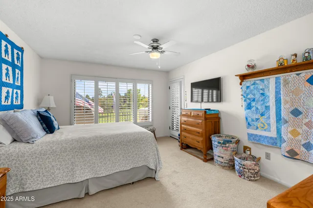 a living room with lots of furniture and a book shelf