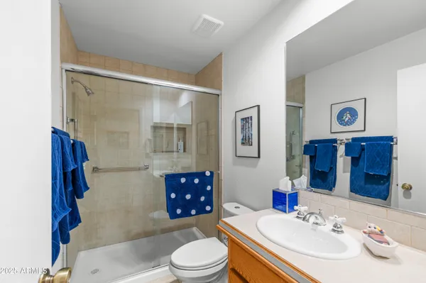a spacious bathroom with a double vanity sink mirror and shower