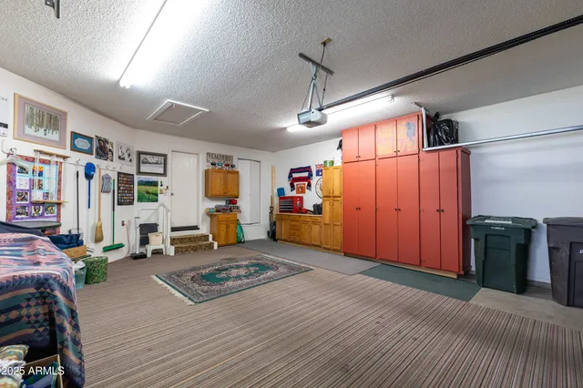 a bedroom with a bed furniture and a large window